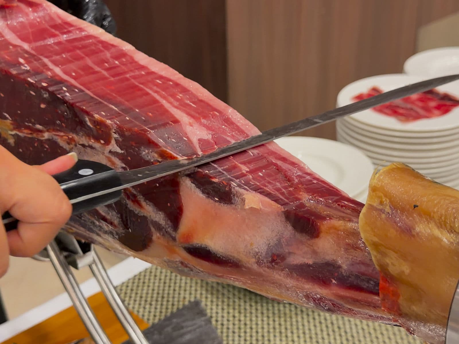 Iberico acorn-fed ham on the ham stand, during carving.
